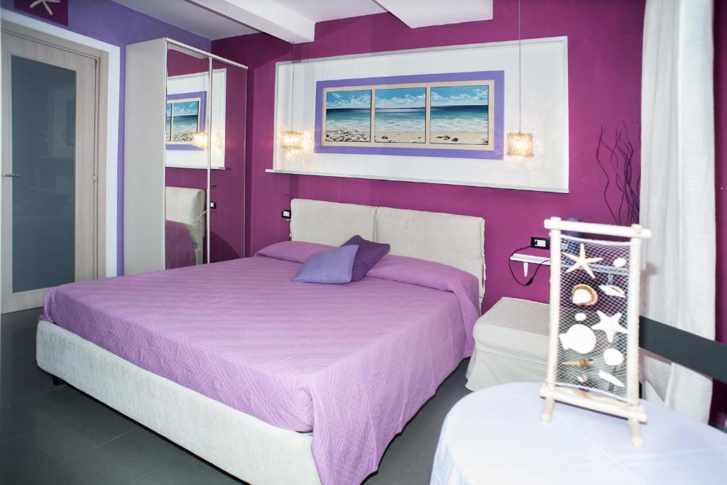 Postel nebo postele na pokoji v ubytování I Coralli rooms & apartments