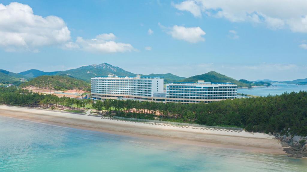 a hotel on the beach next to the water at C-One Resort Jaeundo in Sinan