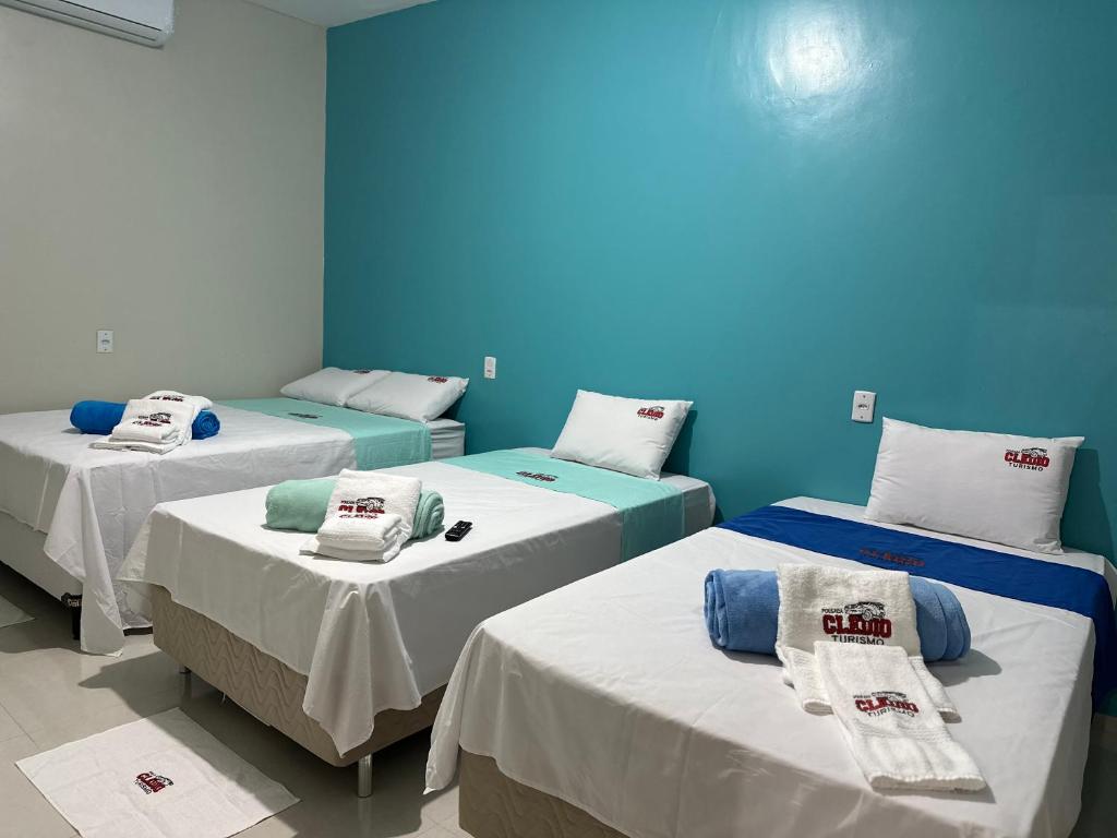 three beds in a room with blue walls at POUSADA E AGENCIA CLEDIO TURISMO in Barreirinhas
