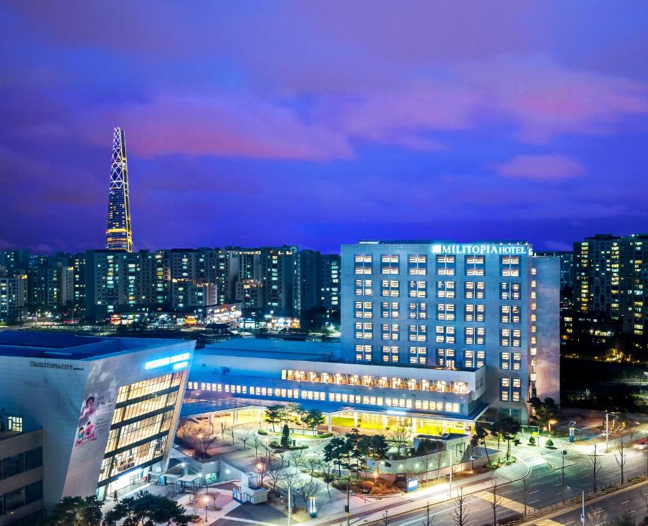 a large building in a city at night at Wirye Militopia Hotel in Seongnam