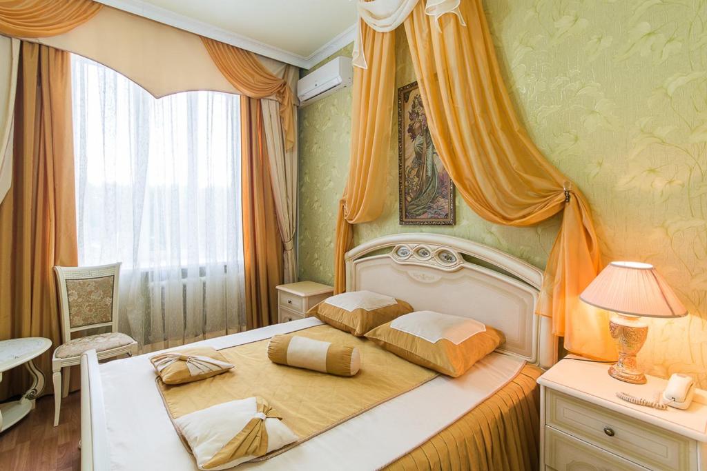 a bedroom with a bed with two pillows on it at Profsoyuznaya Hotel in Nizhny Novgorod