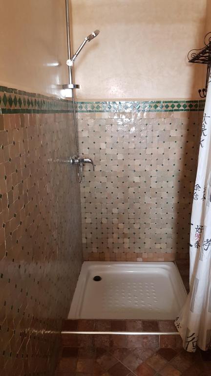 y baño con ducha y cortina de ducha. en Havre de paix pied dans l'eau, en Agadir