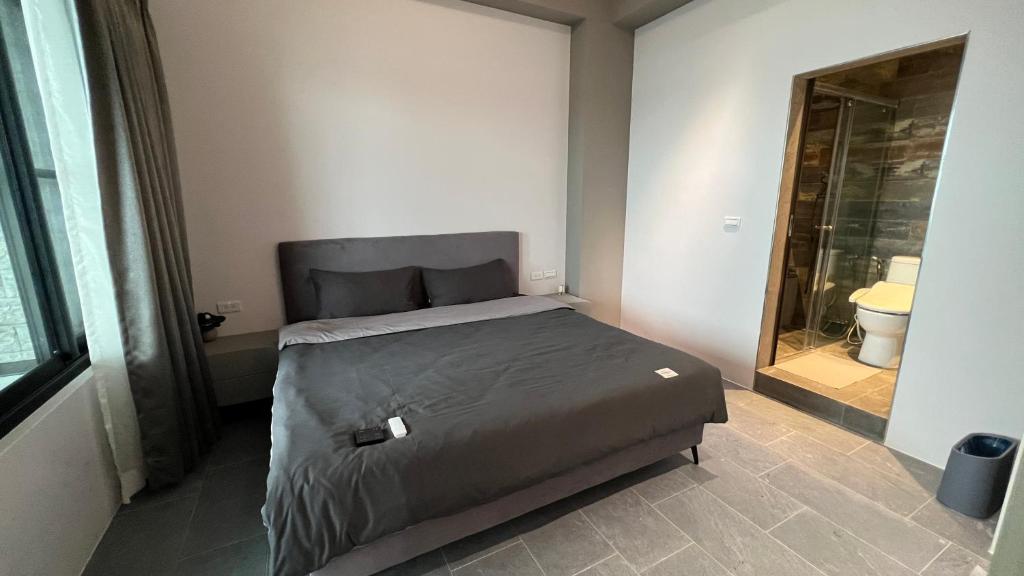 Postel nebo postele na pokoji v ubytování 沒有名字Unnamed B&B