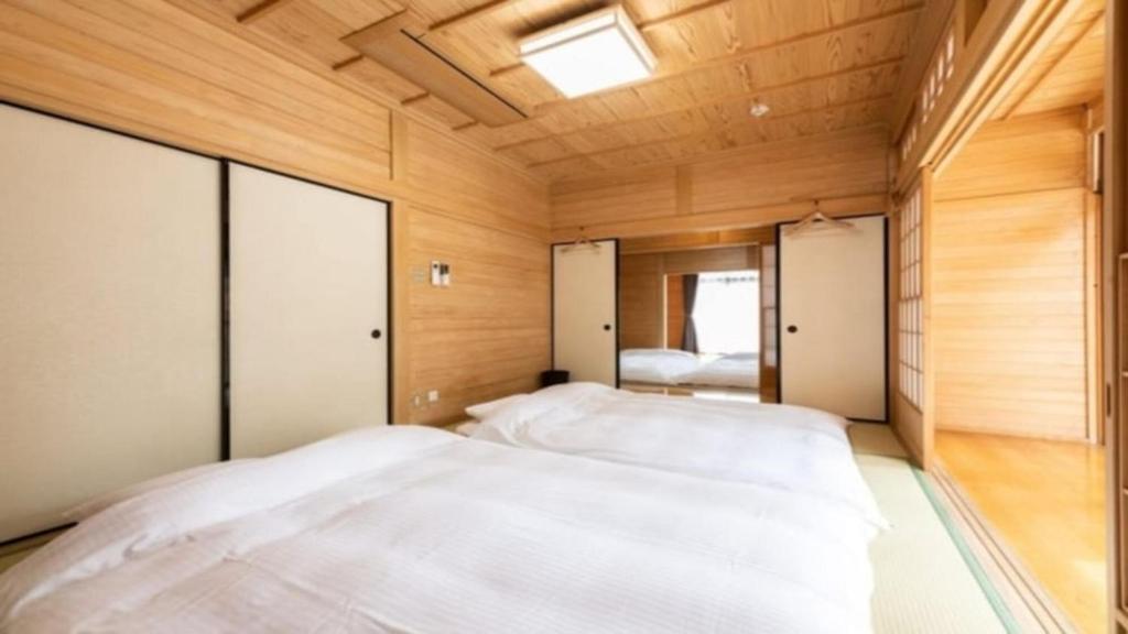 Postel nebo postele na pokoji v ubytování YUFUIN O-YADO YUKI ONSEN