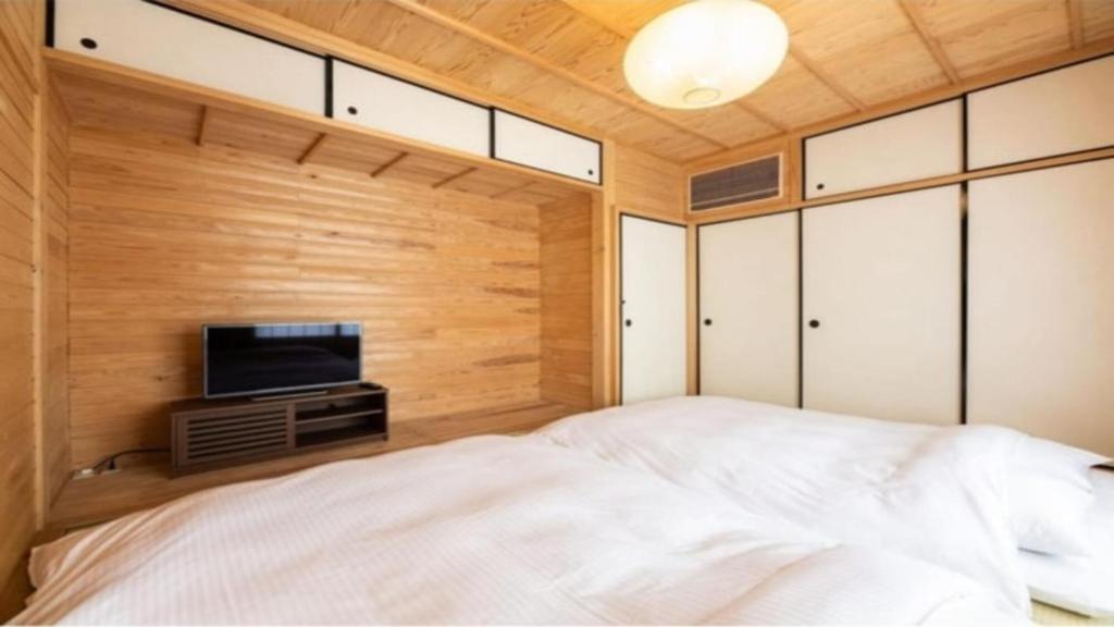 Postel nebo postele na pokoji v ubytování YUFUIN O-YADO YUKI ONSEN