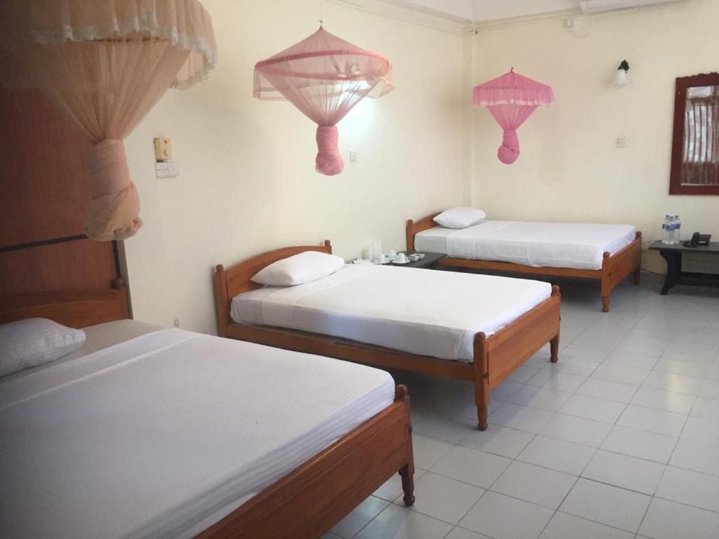 Postel nebo postele na pokoji v ubytování Hotel Shalini