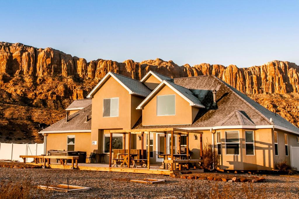a house with a mountain in the background at Moab Desert Home, 4 Bedroom Private House, Sleeps 10, Pet Friendly in Moab