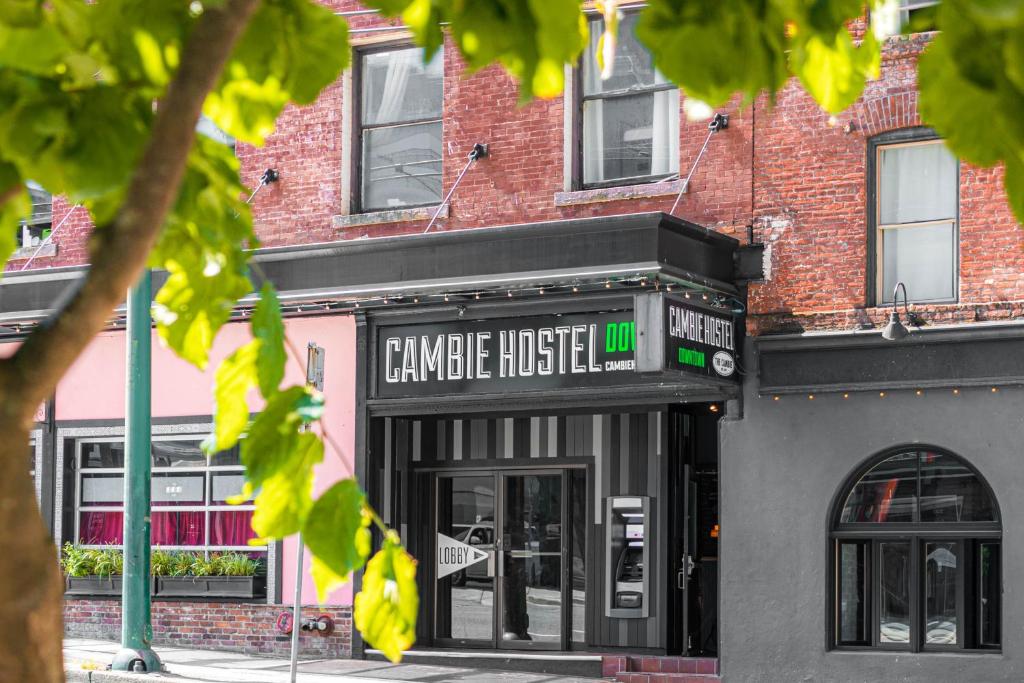 a building with a sign that reads unique inside at The Cambie Hostel Seymour in Vancouver