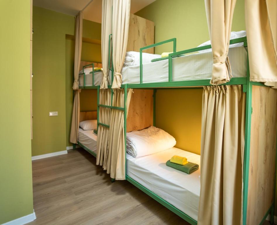 a room with three bunk beds in a hostel at La Casa EmilioAngi in Yerevan
