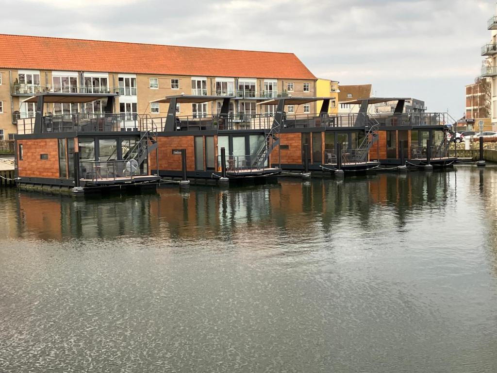 a group of boats docked at a dock on the water at MarinaVilla in Nykøbing Falster