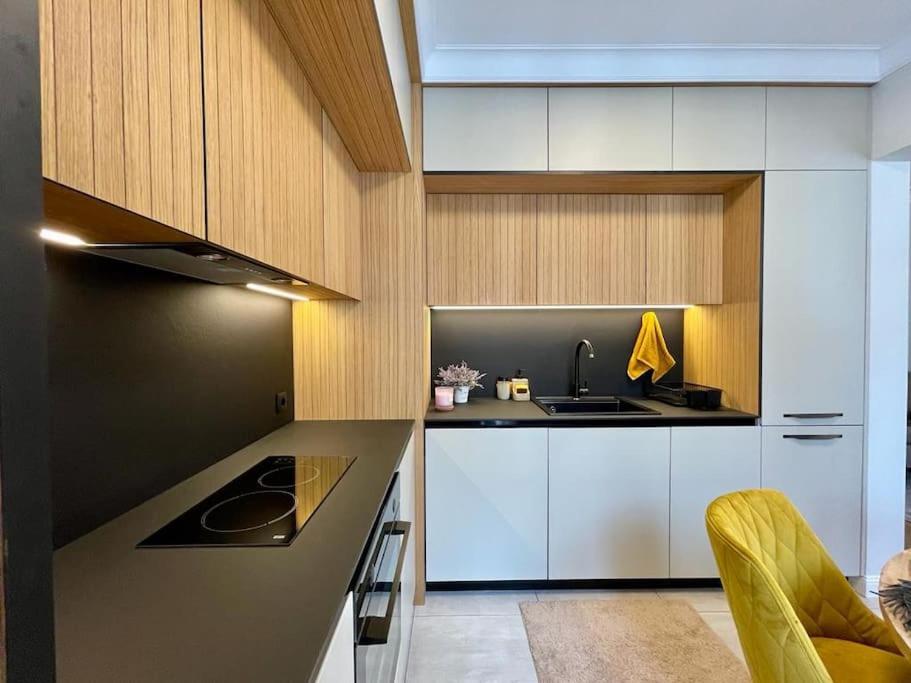a kitchen with white cabinets and a sink at Luxury 2 Bedroom Top Central Apartment in Sofia