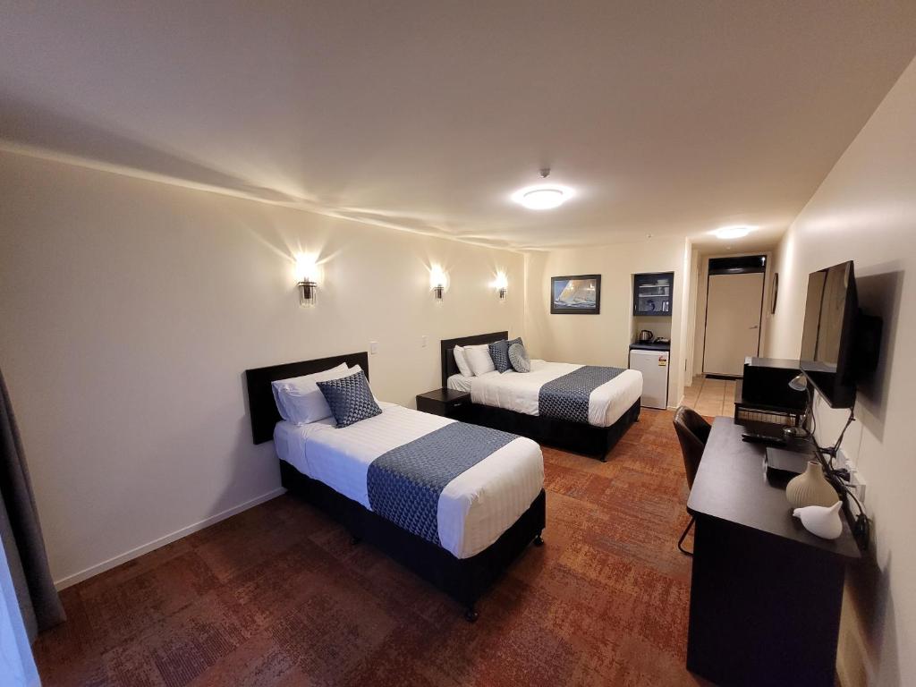 Ένα ή περισσότερα κρεβάτια σε δωμάτιο στο City of Sails Motel