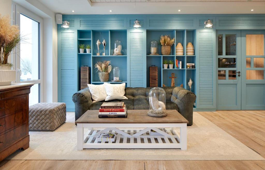 a living room with a couch and a coffee table at Beach Apartments Büsum in Büsum