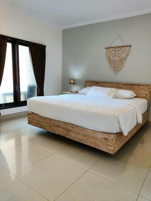 Postel nebo postele na pokoji v ubytování Radha Bali Hotel