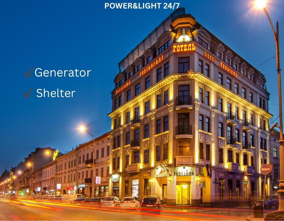 a large building on a city street at night at PANORAMA Lviv Hotel in Lviv