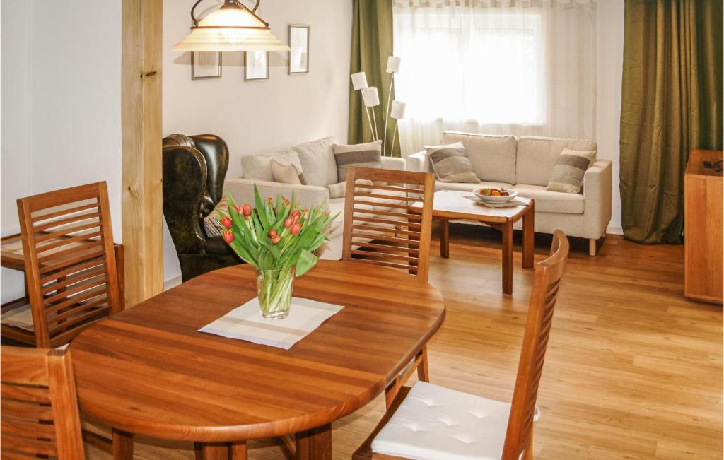 a kitchen and living room with a table and chairs at Gorgeous Apartment In Ribnitz-damgarten With Wifi in Ribnitz-Damgarten