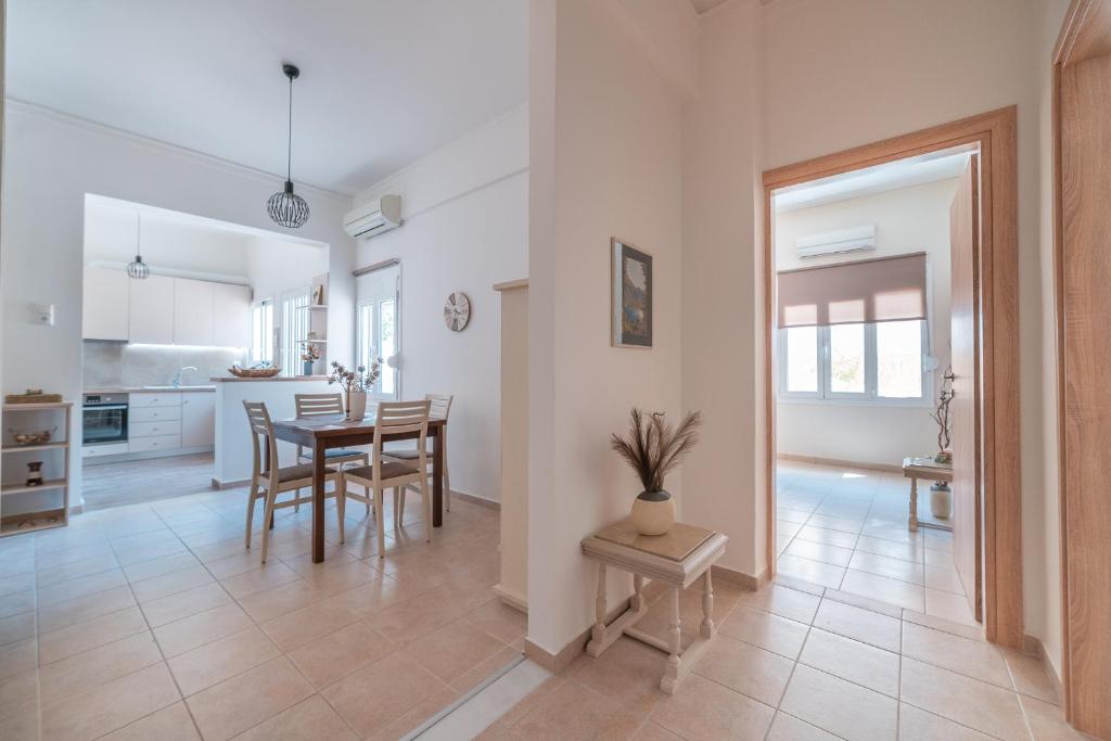 a kitchen and dining room with a table and chairs at Stylish Central Renovated Apartment in Heraklio