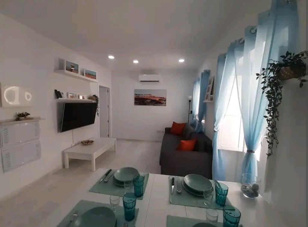 a living room with a couch and a table at Casa Playa Caleta, a 4 minutos de la playa in Cádiz