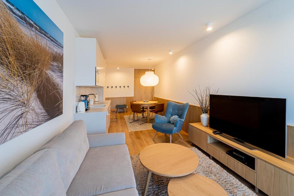 Televízia a/alebo spoločenská miestnosť v ubytovaní Apartament DUNE SurfingBird Dźwirzyno