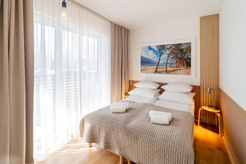 Posteľ alebo postele v izbe v ubytovaní Apartament DUNE SurfingBird Dźwirzyno