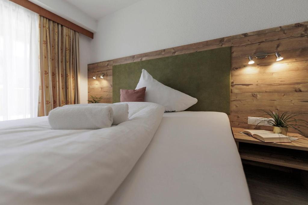 Postel nebo postele na pokoji v ubytování Hotel Neuwirt
