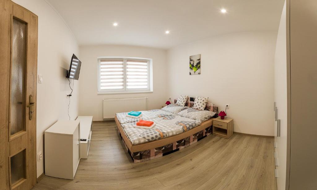 um quarto com uma cama no meio de um quarto em Helijan Ubytovanie em Nesvady