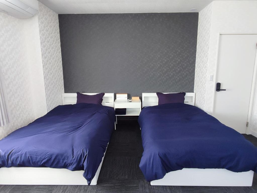 Postel nebo postele na pokoji v ubytování Fuji Guest House Ao
