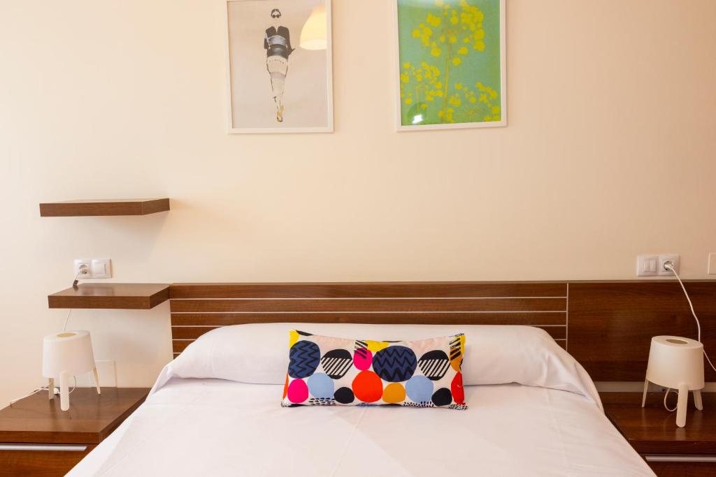 a bedroom with a bed with a pillow on it at Apartagal-Urb. Traiñeira in O Vicedo