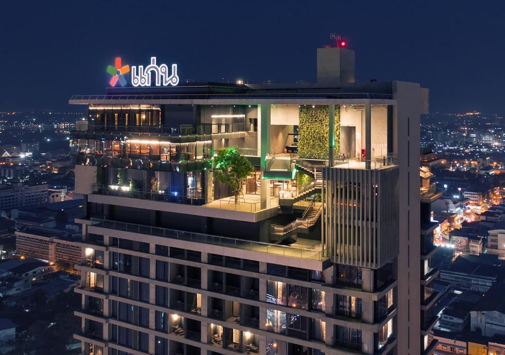 a tall building with a lit up sign on top of it at Ad Lib Hotel Khon Kaen in Khon Kaen