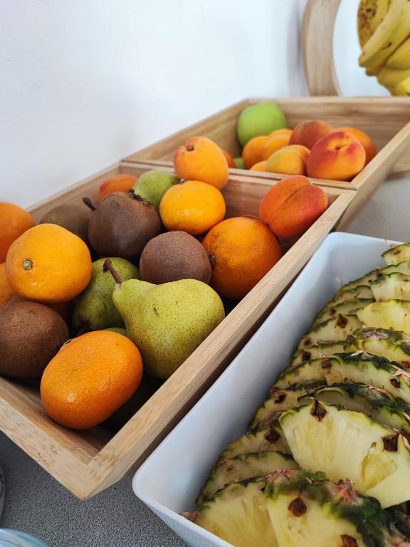 two wooden trays filled with fruits and a fish at St Breca in Newquay
