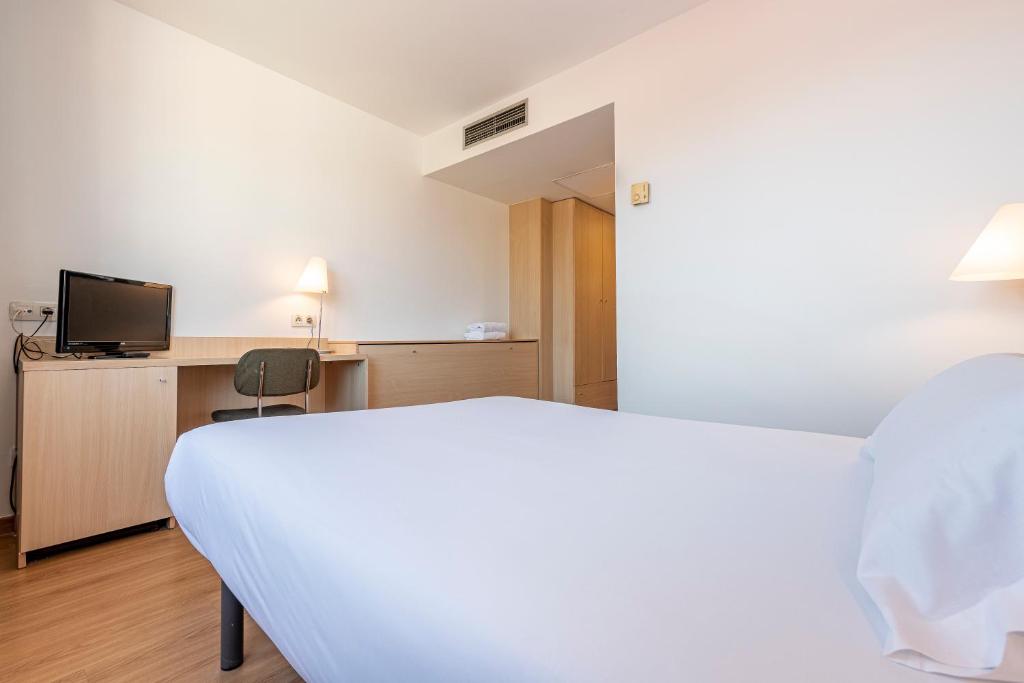 Postel nebo postele na pokoji v ubytování Hotel Basic