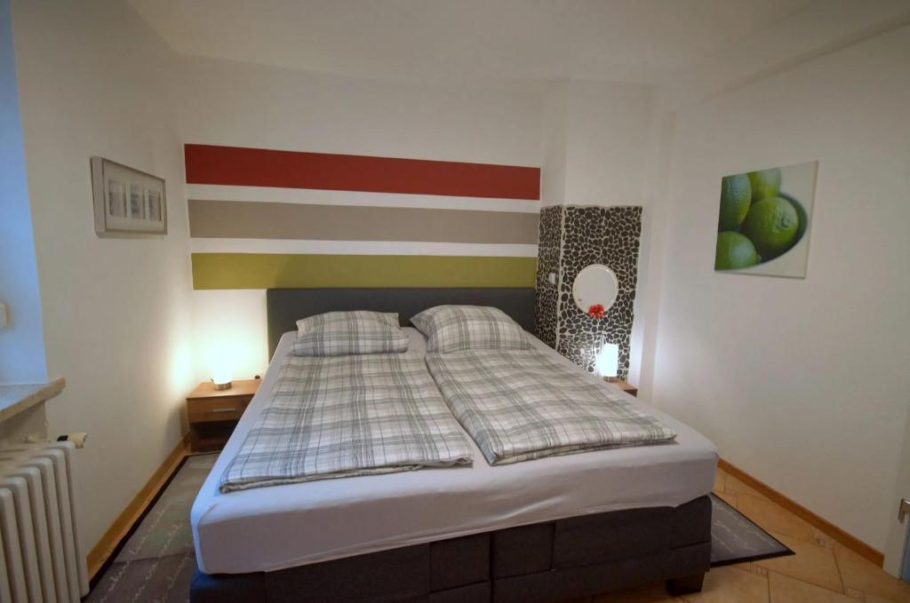 a bedroom with a bed with a american flag on the wall at Ferienwohung DaHeim in Bovenden