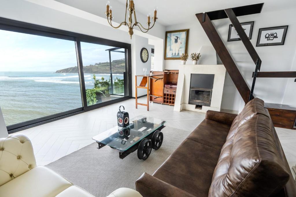 a living room with a couch and a table at Mundaka Beachfront House in Mundaka