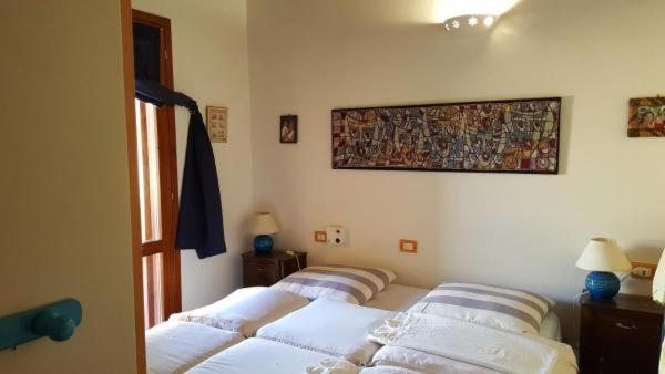 Postel nebo postele na pokoji v ubytování Residenze Coda Cavallo