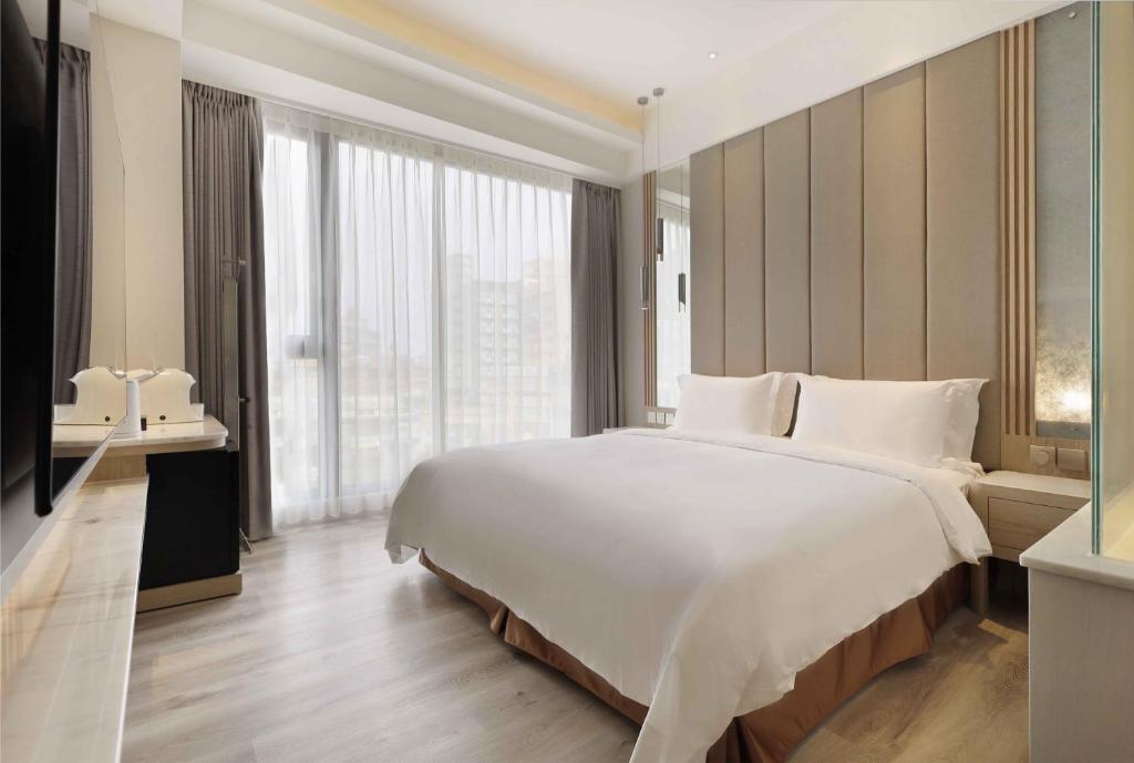 Postel nebo postele na pokoji v ubytování Gamalan Star Hotel