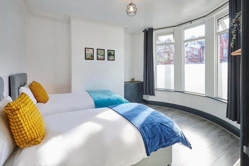 a bedroom with two beds and a window at Host & Stay - Rathbone Road in Liverpool