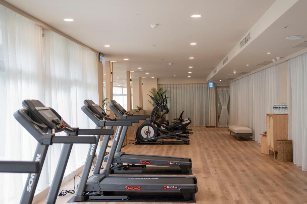 a gym with a row of treadmills and machines at H Resort in Checheng