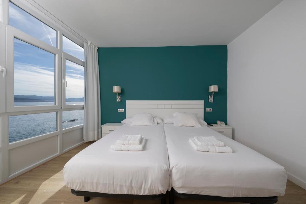 Cama o camas de una habitación en Hotel Mar de Fisterra
