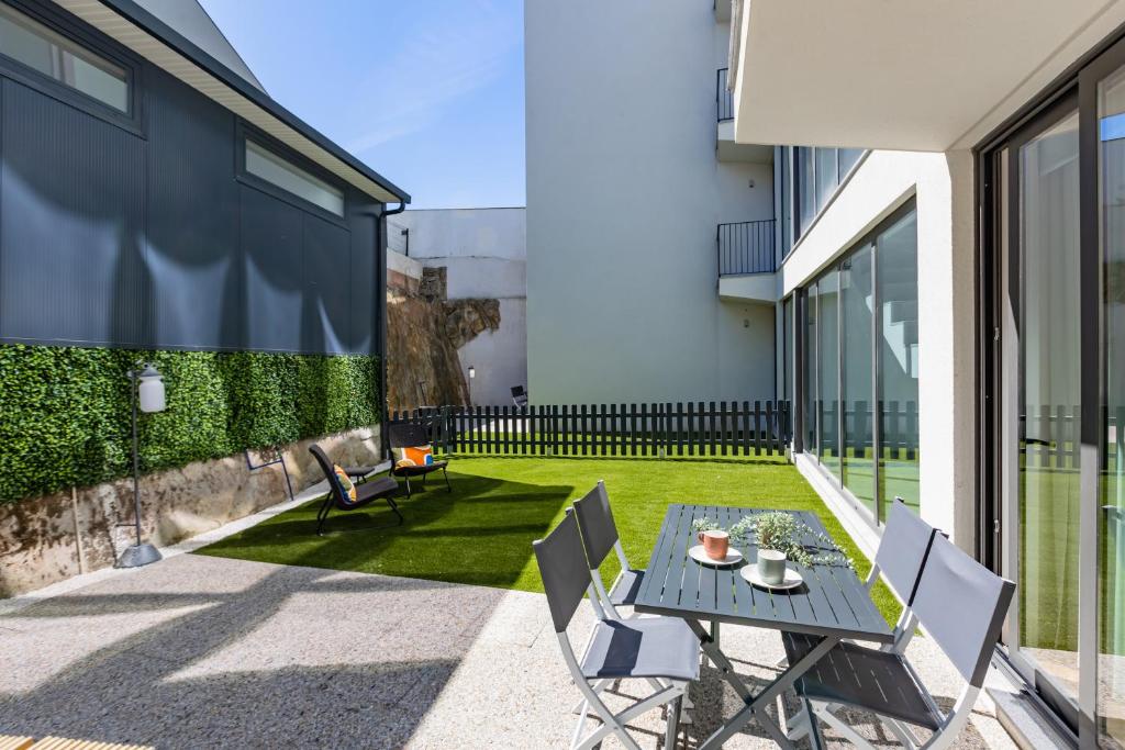 a patio with a table and chairs on a building at Pestana Apartments - Premium in Porto