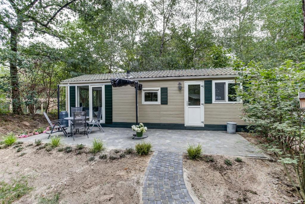 a tiny house with a patio in a yard at Norgerchalet in Norg