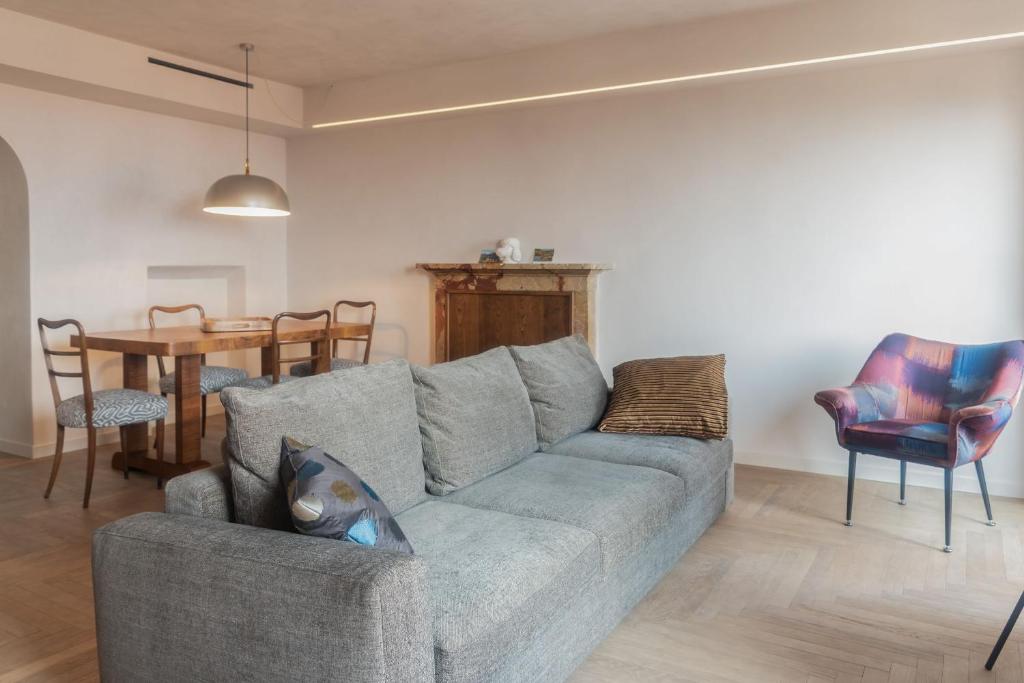 a living room with a gray couch and a table at Leoni 7 in Menaggio