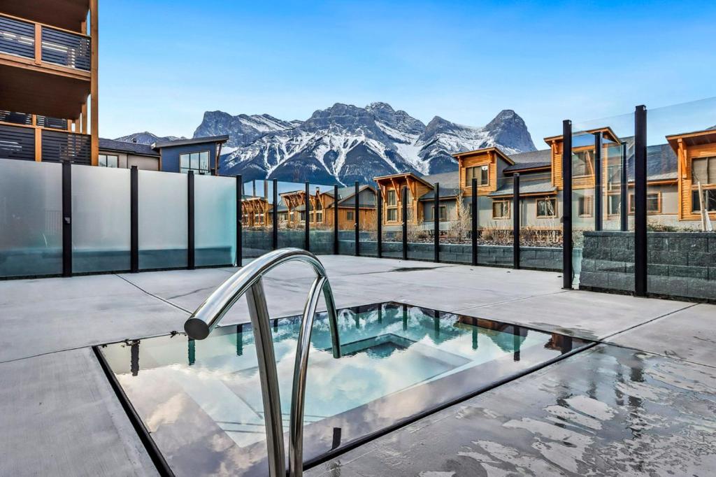 a swimming pool with a mountain in the background at White Spruce Condo by Gordon Property Management in Canmore