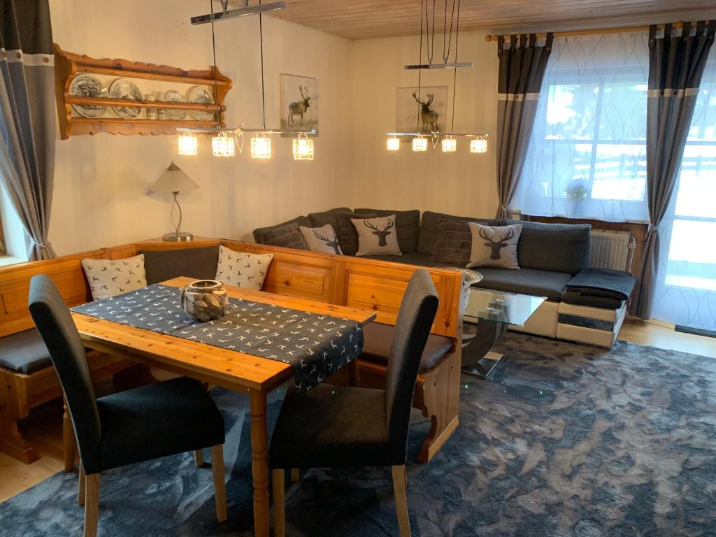 a living room with a couch and a table at Ferienresidenz Am Hauchen in Reit im Winkl