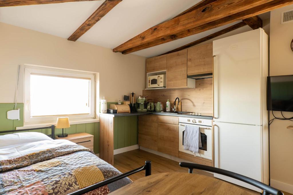 eine Küche mit einem Bett und einem Tisch in einem Zimmer in der Unterkunft Villa Arkadia in Września
