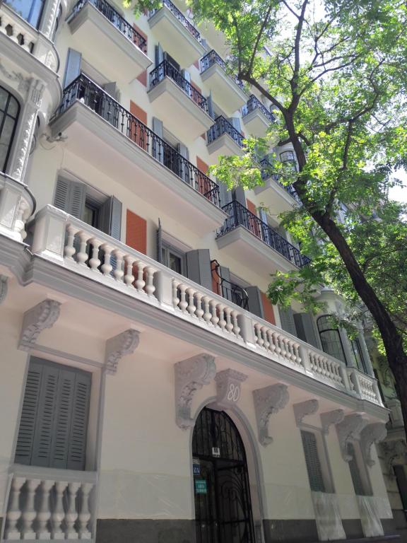 a white building with a balcony and a door at SPACE CENTER MADRID in Madrid