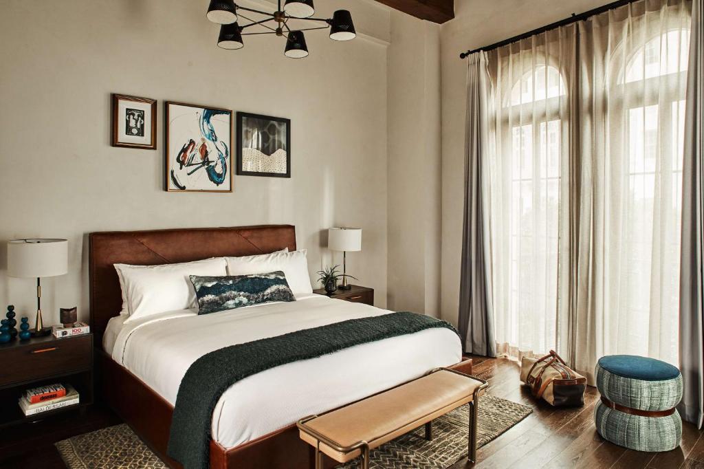 a bedroom with a large bed and a window at Hotel Figueroa, Unbound Collection by Hyatt in Los Angeles