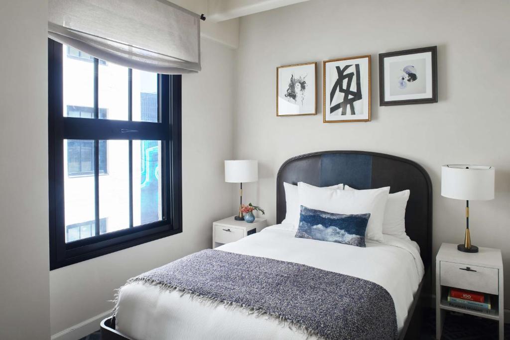 a bedroom with a bed and a window at Hotel Figueroa, Unbound Collection by Hyatt in Los Angeles