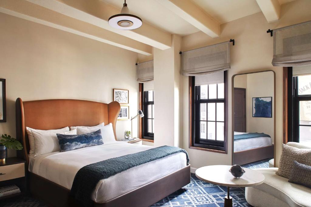 a bedroom with a large bed and a couch at Hotel Figueroa, Unbound Collection by Hyatt in Los Angeles