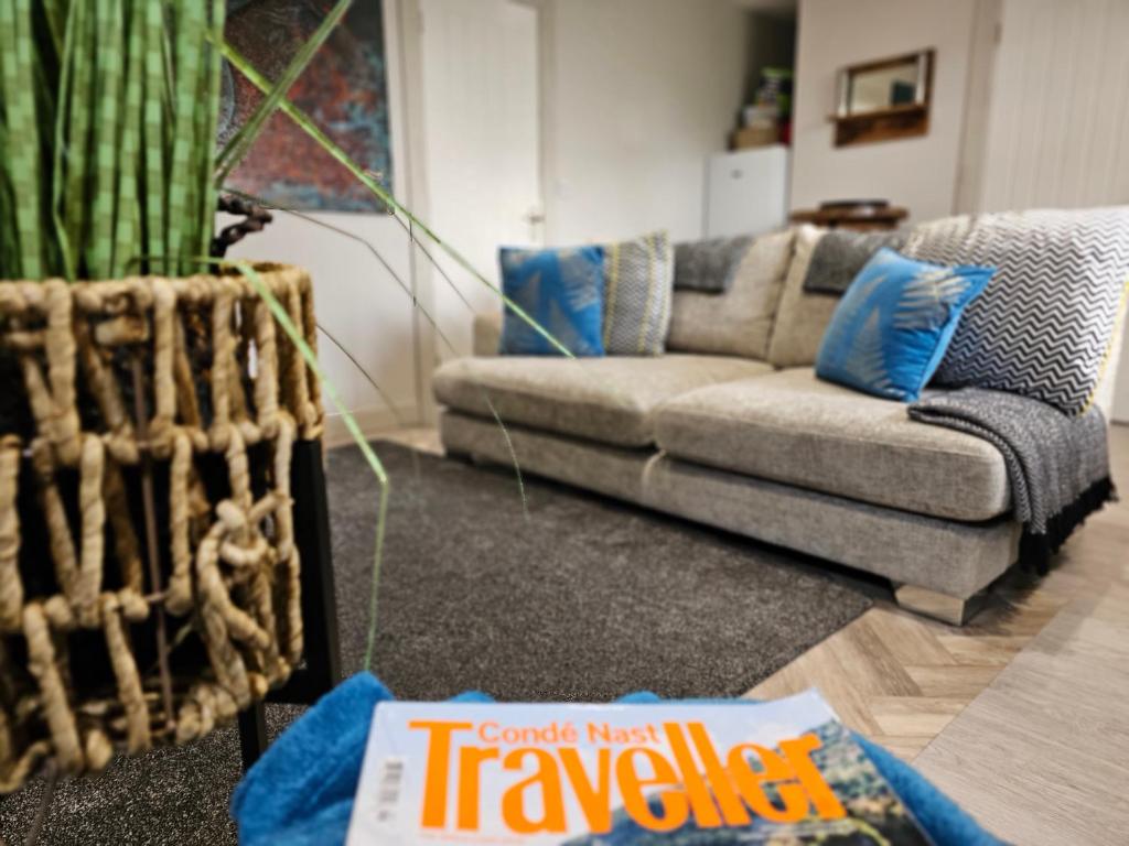 a living room with a couch and a book on the floor at the G-RANGE Together in Longford