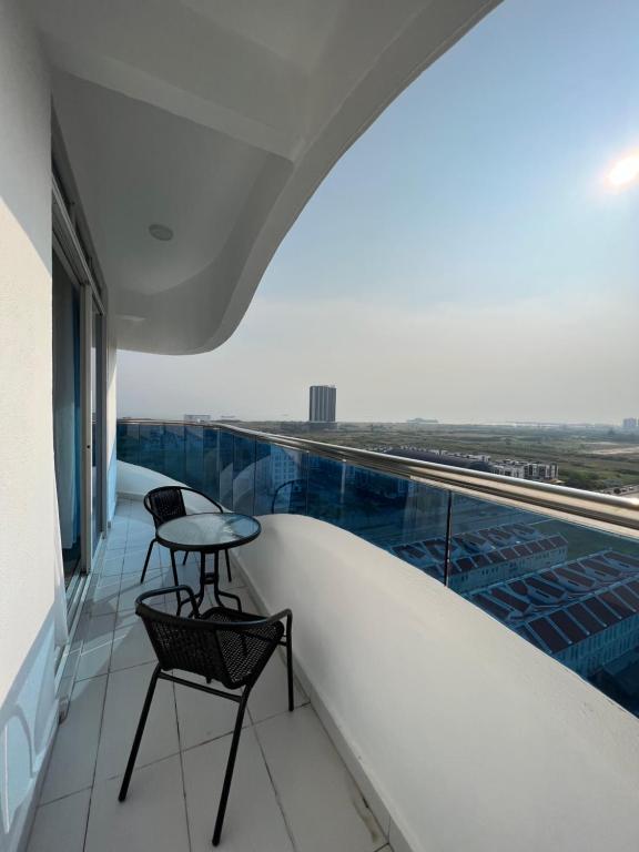 een balkon met een tafel en stoelen in een gebouw bij SNHomestay1826 Sea View @ The Wave Residence in Melaka